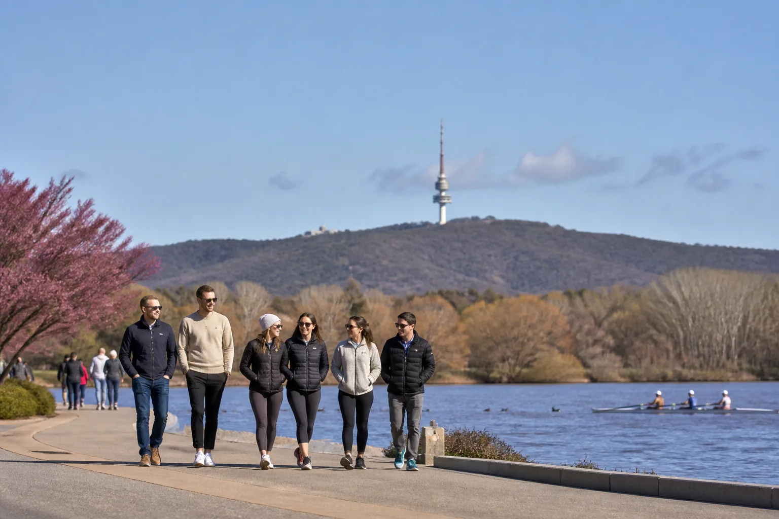 Two people chatting beside Lake Burley Griffin in Canberra