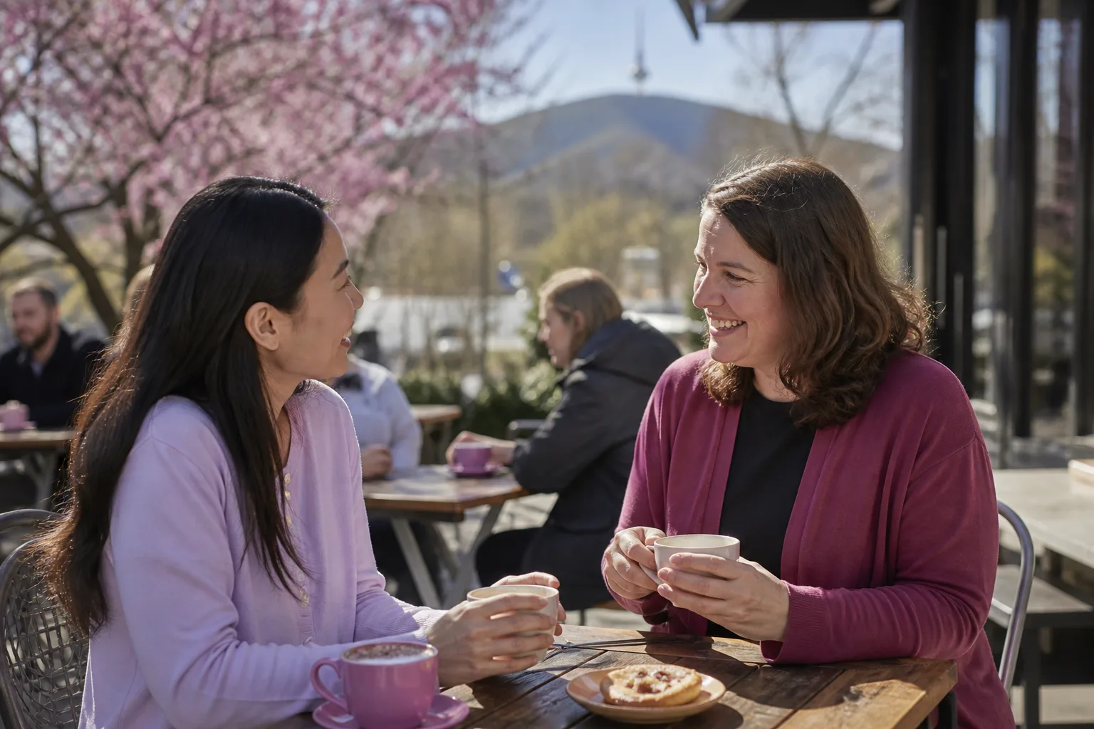 Two adults meeting for coffee at a busy Canberra cafe