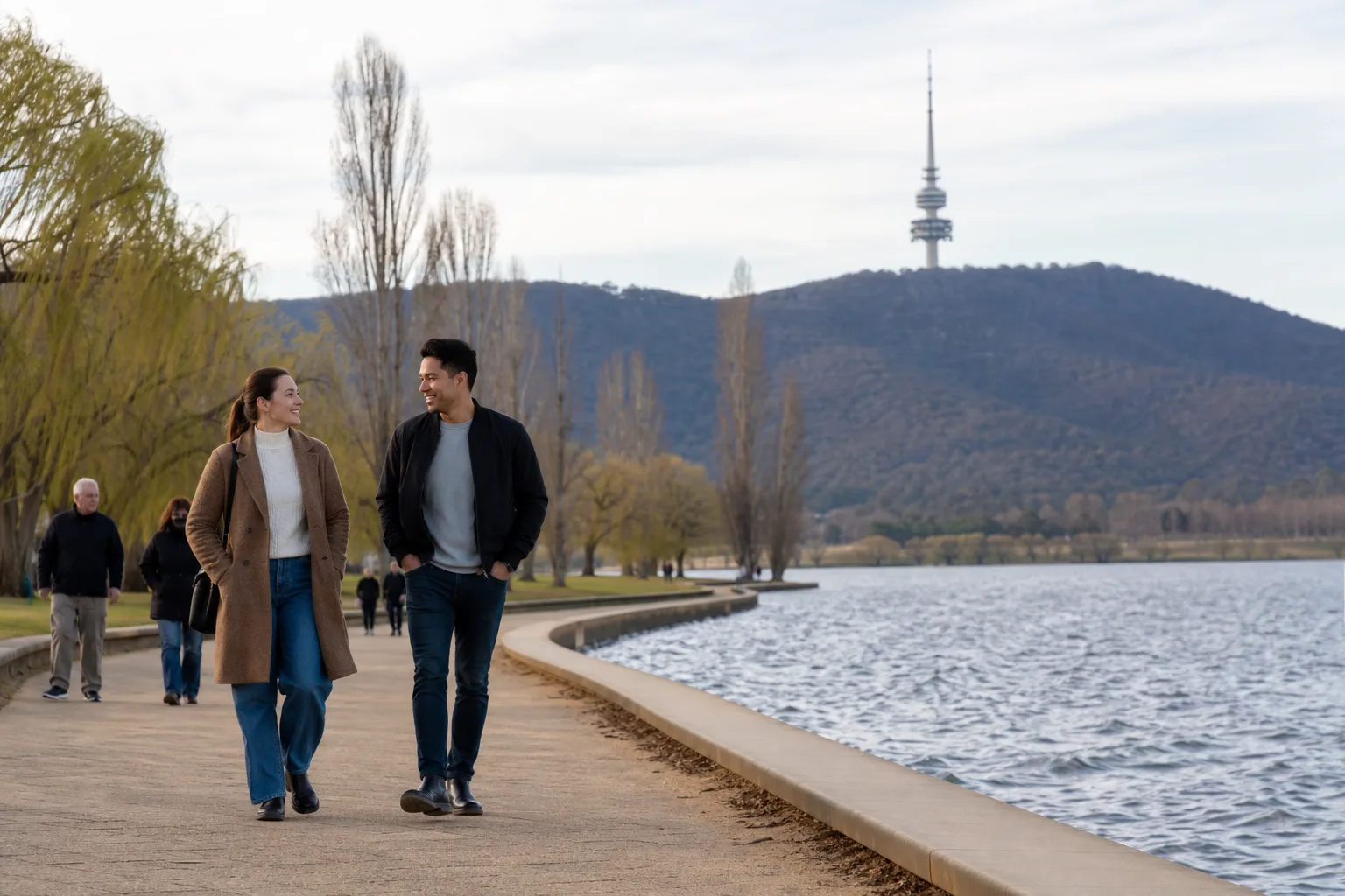 Two people walking beside Lake Burley Griffin on a Canberra first date